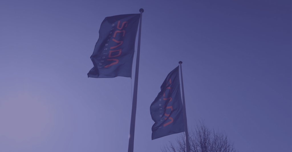 SCADA International flag waving against a clear blue sky, representing innovative ETRM systems for energy trading