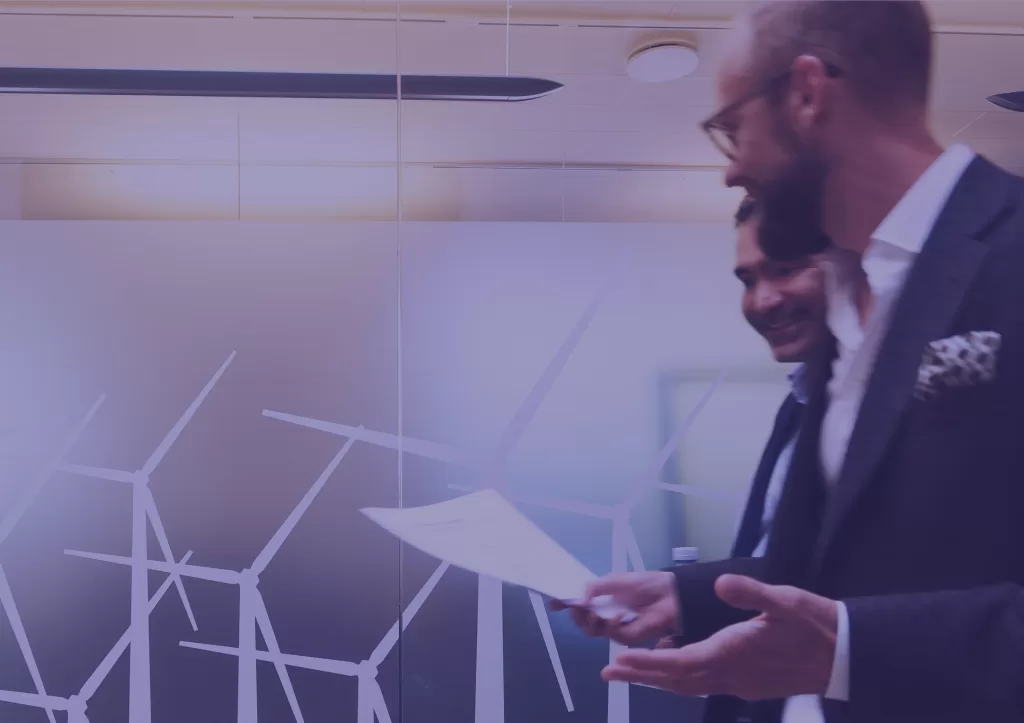 Two colleagues engaged in a discussion about risk assessment in Opoura